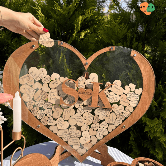 A beautifully crafted heart-shaped wedding guest book frame filled with handwritten messages on wooden hearts. A unique and personalized wedding keepsake for couples to cherish special memories.