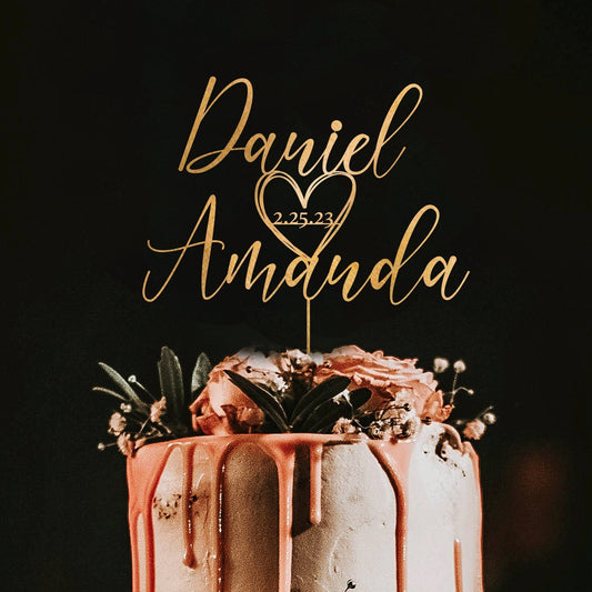 This elegant gold cake topper featuring the names "Daniel" and "Amanda" along with their wedding date "2.25.23" creates a personalized and sophisticated touch to elevate your wedding cake.