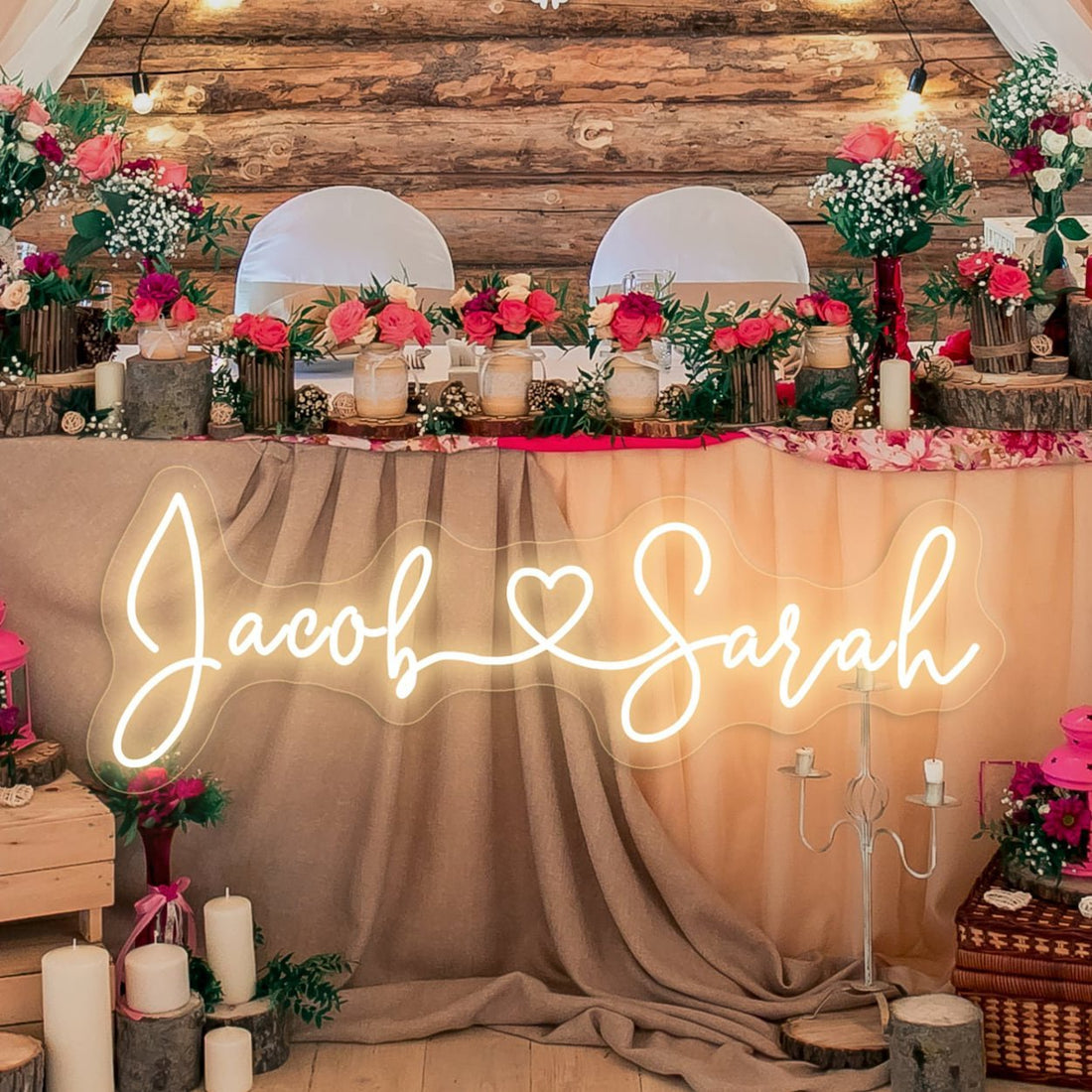 A beautifully illuminated custom neon sign featuring the couple's names adds a romantic glow to the wedding décor. Perfect for a sweetheart table or reception backdrop, creating a warm and personalized ambiance.