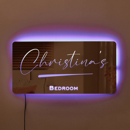 This personalized neon mirror with "Christina's Bedroom" illuminated in soft purple adds a stylish and customized touch to any living space, enhancing the ambiance with modern elegance and warmth.