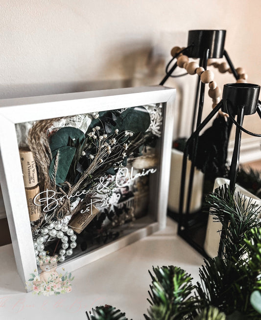 Personalized wedding shadow box with dried florals, wine corks, and pearls—an artistic display of love and memories that makes a truly unique keepsake.