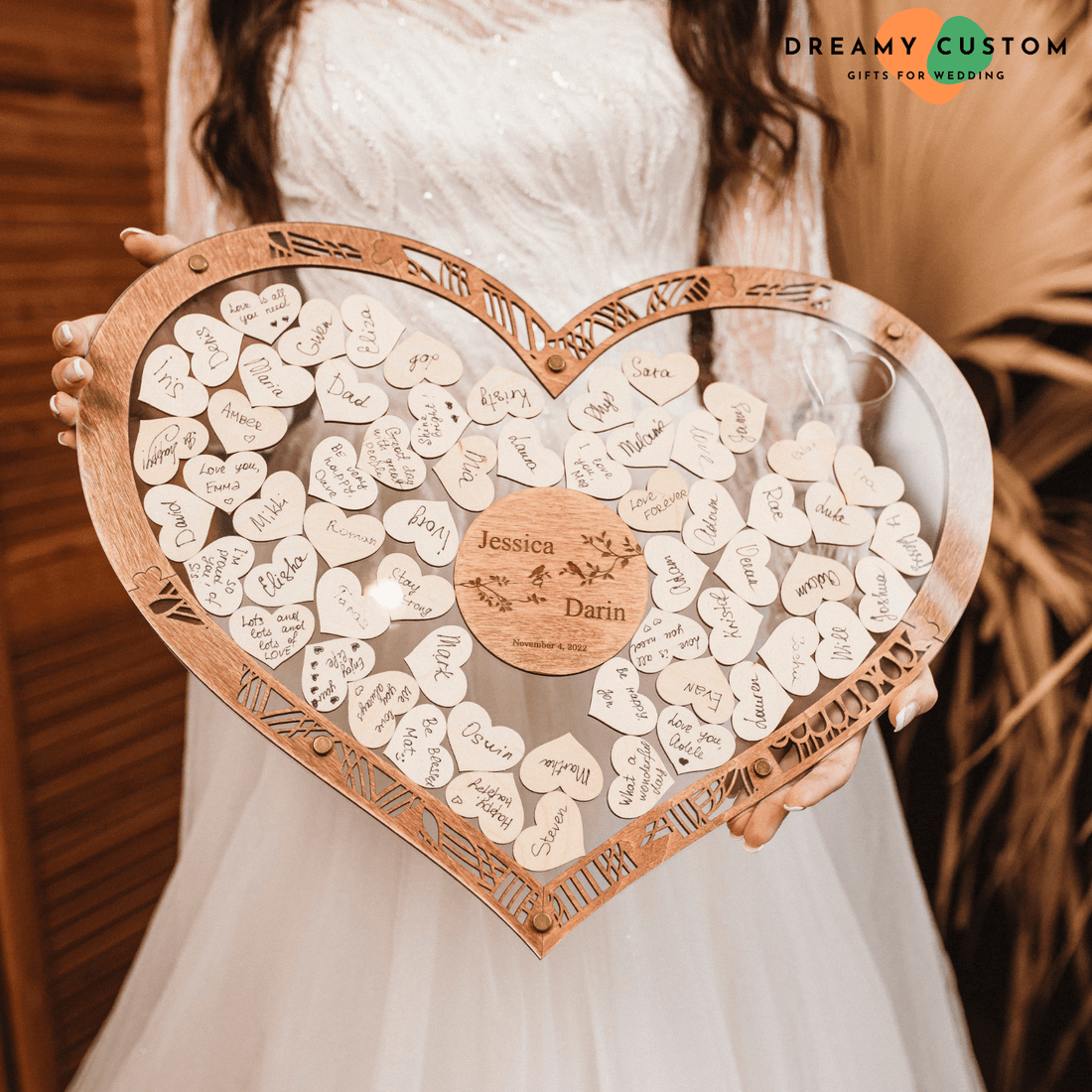 Personalized heart-shaped wooden guest book displayed at wedding reception