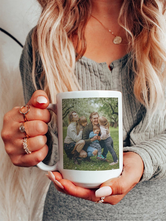 Custom photo coffee travel mug held in hand, personalized with a family portrait, ideal sentimental gift.