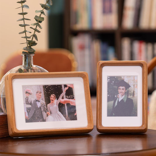 Custom wedding photo frame featuring a couple celebrating their wedding day with a joyful photo, framed in natural wood.