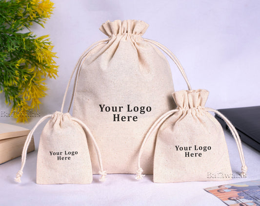 Group of organic cotton drawstring bags with custom logo, various sizes.