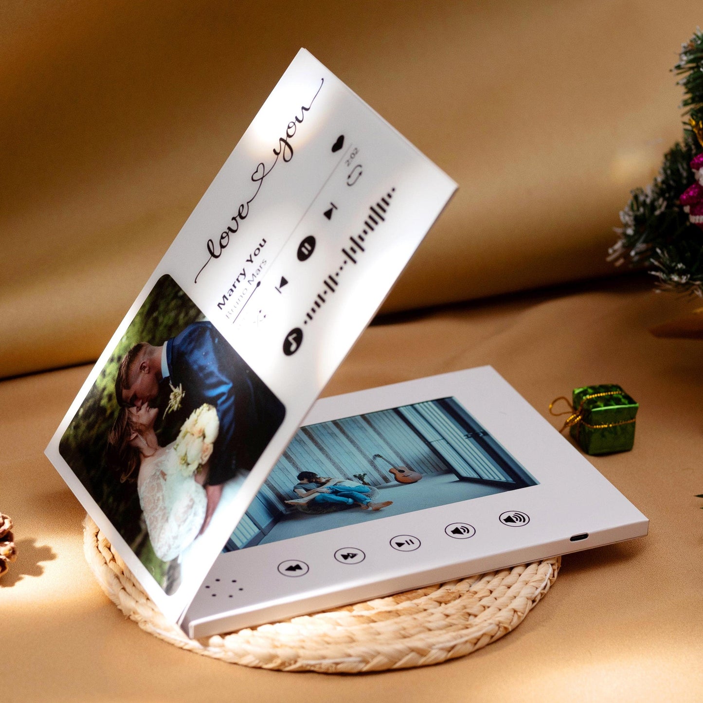 Personalized wedding photo video book displayed with a Christmas gift in the background.