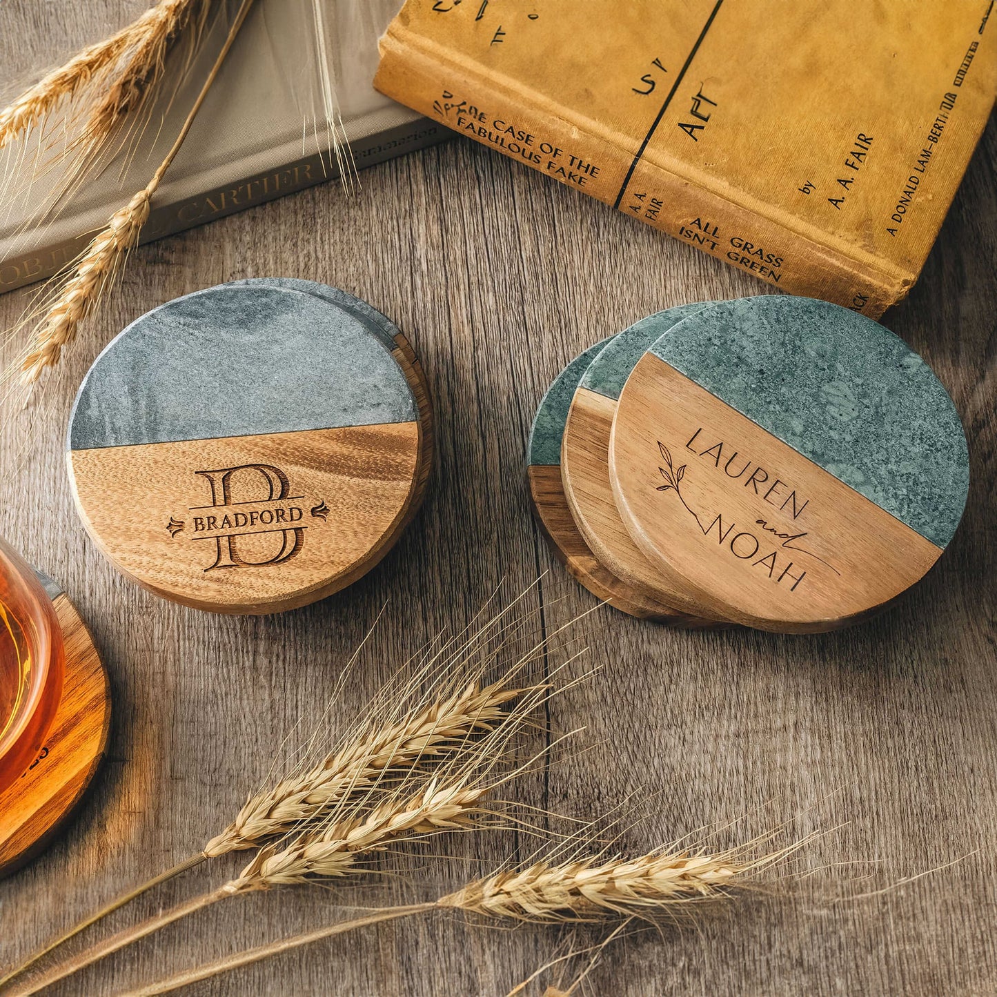 Personalized marble and wood coasters with engraved initials and family names.