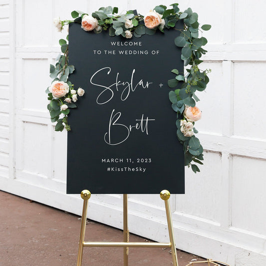 Custom wedding welcome sign with floral greenery design featuring the names Skylar and Brett.