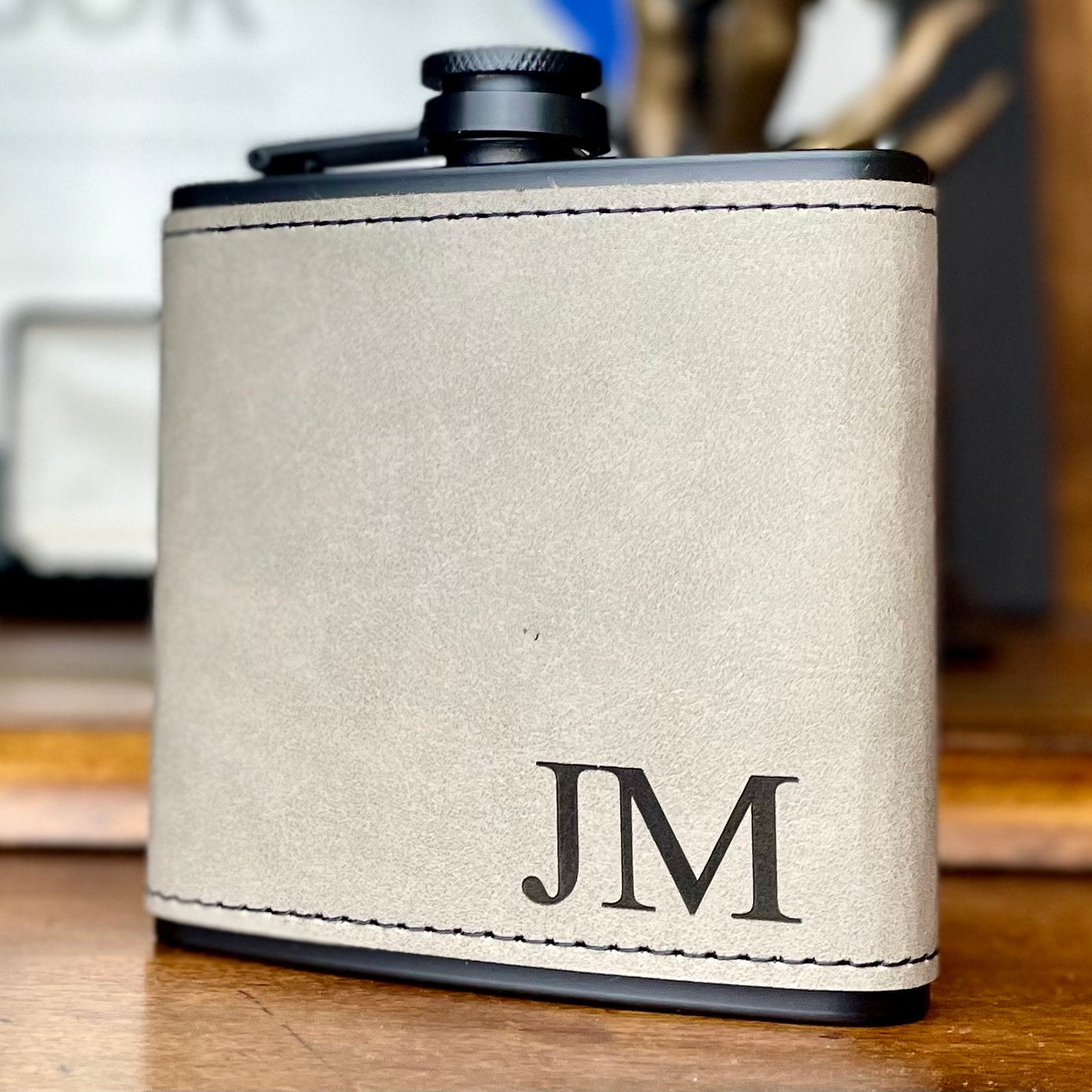 Light grey leather flask with monogram initials 'JM'