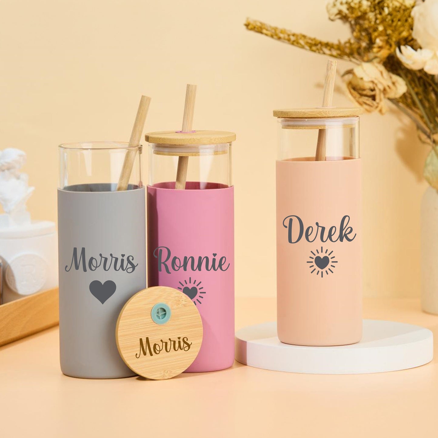 Custom glass tumbler with straw, featuring personalized name.