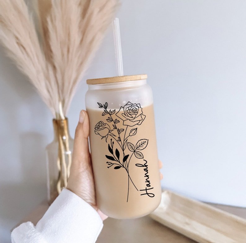 Custom glass tumbler with straw and birth flower design, personalized with the name "Hannah"