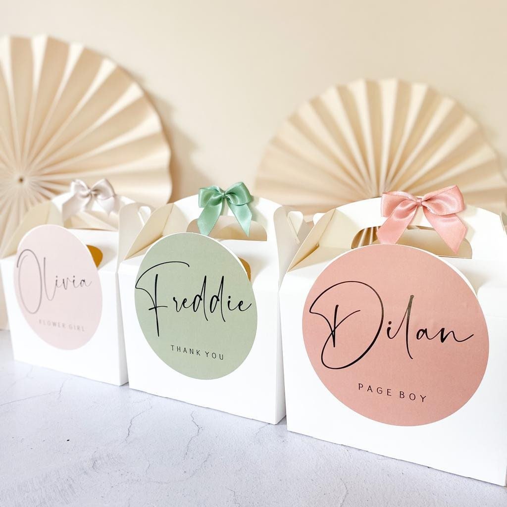 Three wedding gift boxes with name tags: Olivia, Freddie, and Dilan