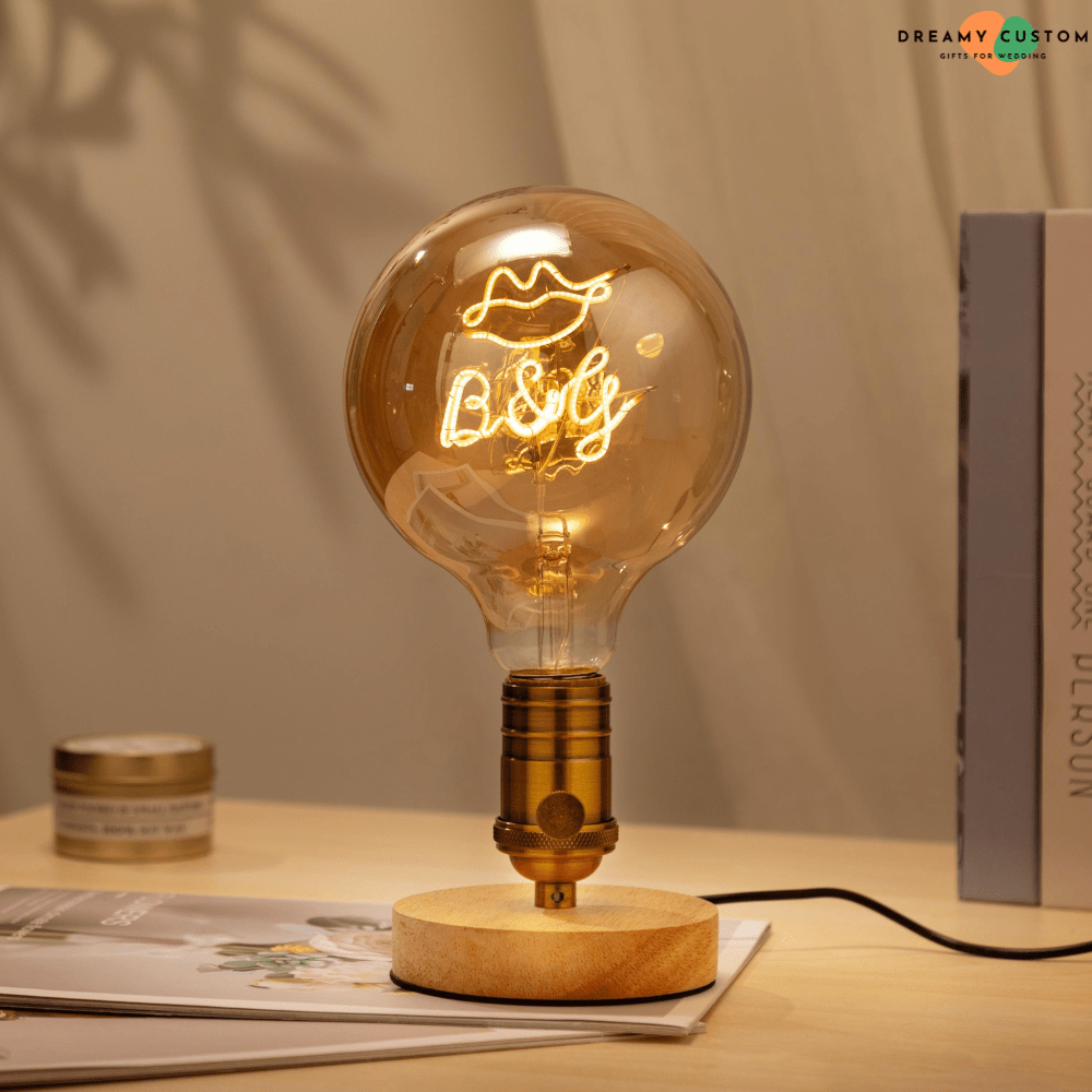 A beautifully crafted personalized filament light bulb with a glowing custom design, mounted on a stylish wooden base. A unique and meaningful gift, perfect for weddings, anniversaries, or special occasions.