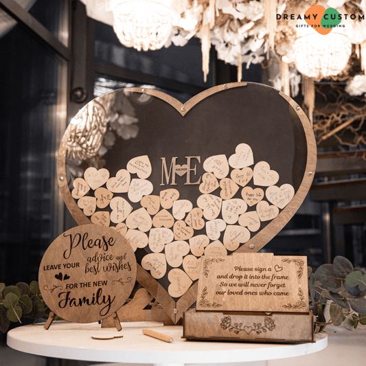 Rustic wedding wooden heart guest book displayed at a reception, featuring a heart-shaped frame filled with signed wooden hearts and personalized initials. A unique and interactive keepsake for capturing guests' heartfelt wishes.