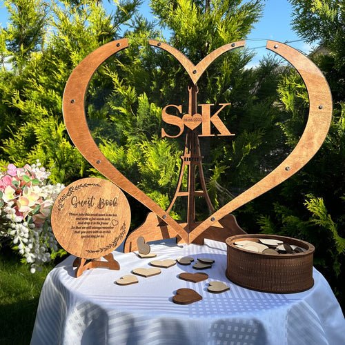 "Wooden heart guest book for weddings" This elegant wooden heart guest book allows guests to sign personalized wooden hearts, making it a unique and memorable keepsake for your wedding.