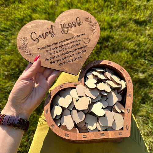 Elegant wooden heart-shaped guest book for weddings, symbolizing love and commitment.