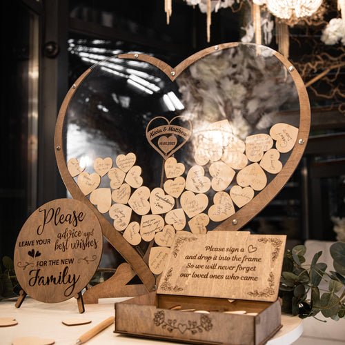 Wooden heart-shaped guest book, perfect for rustic weddings or outdoor events, where guests can leave messages on each heart-shaped wooden piece, creating unforgettable memories.