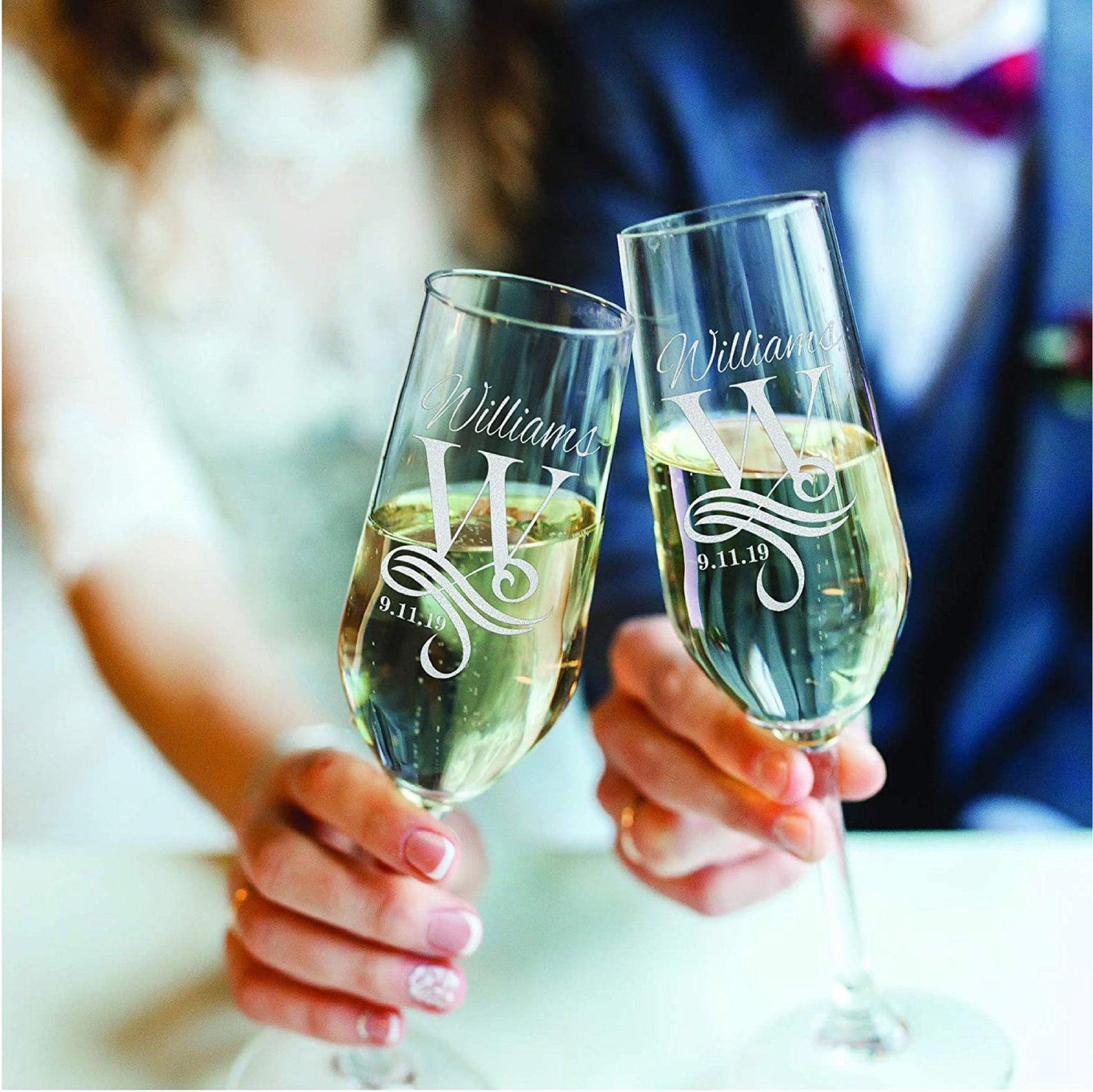 Bride and groom toast using customized wedding champagne flutes