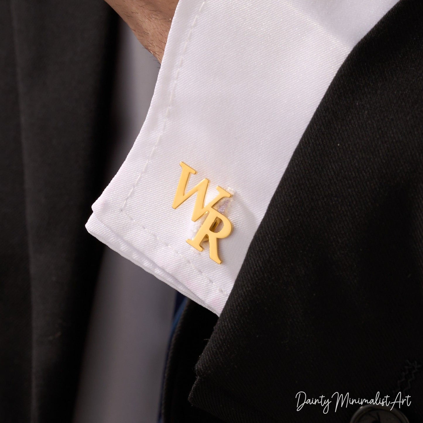 A man wearing personalized gold initial cufflinks featuring the letters WR, adding an elegant touch to his formal attire.