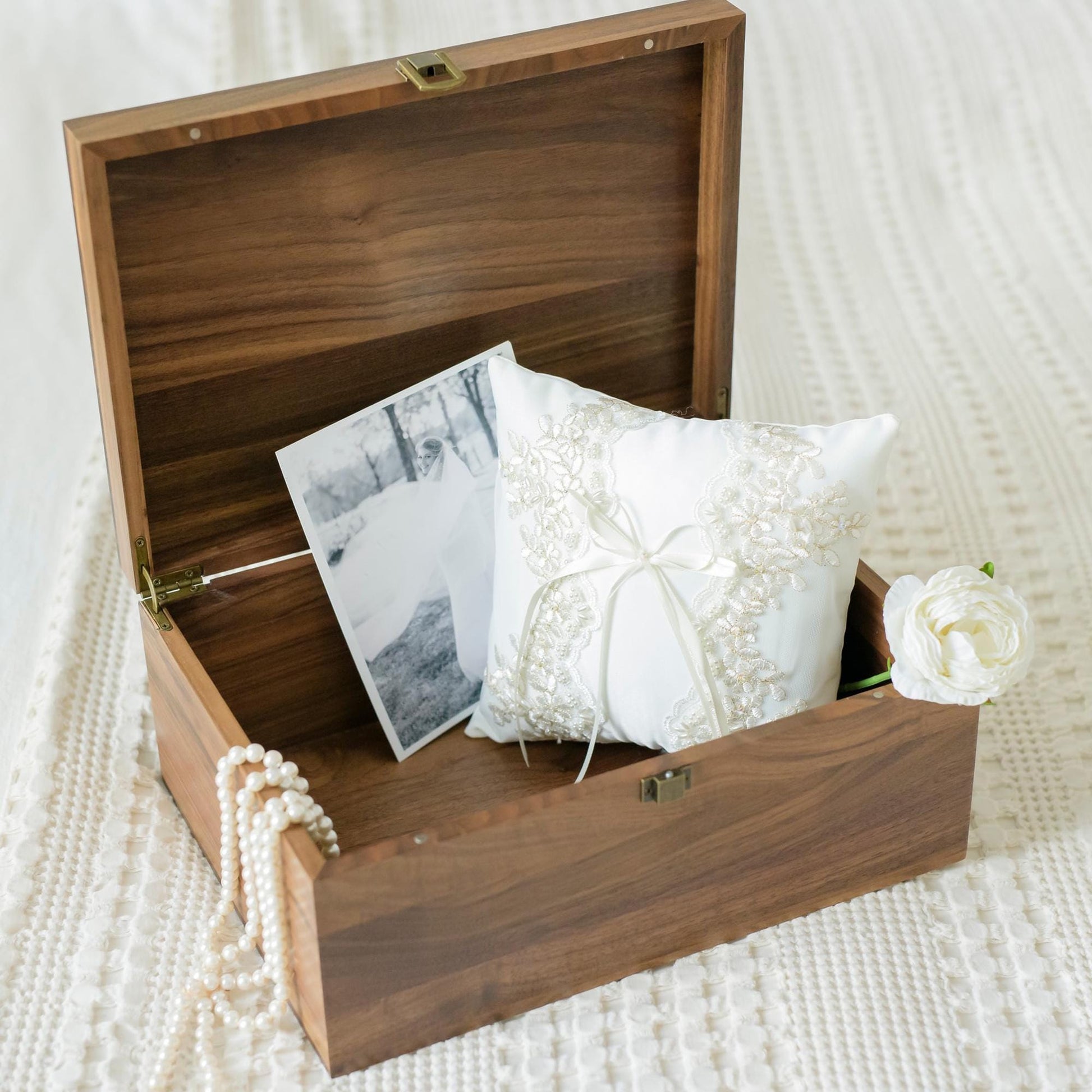 Open view of walnut keepsake box displaying bridal mementos including a lace wedding pillow, a pearl necklace, and wedding photo, perfect for cherished memories.