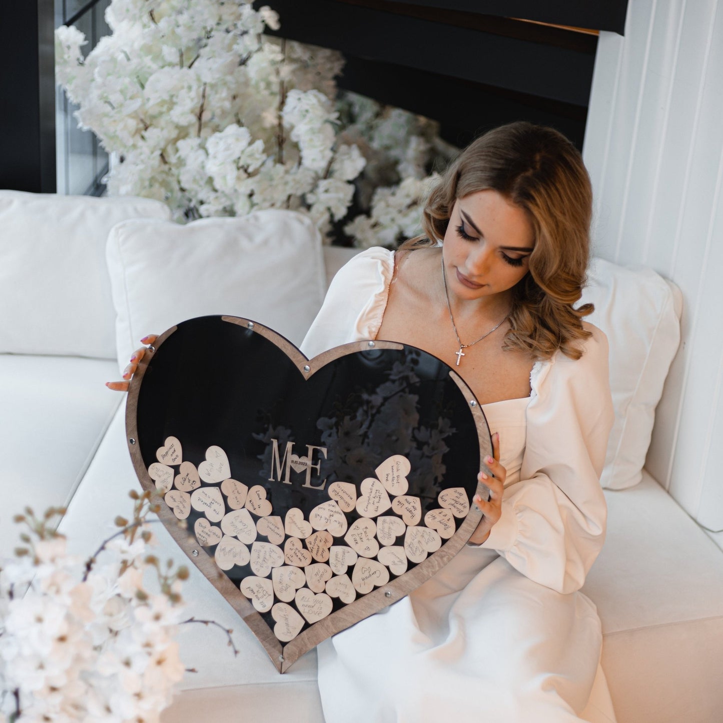 Close-up of the wooden heart guest book showcasing heart pieces