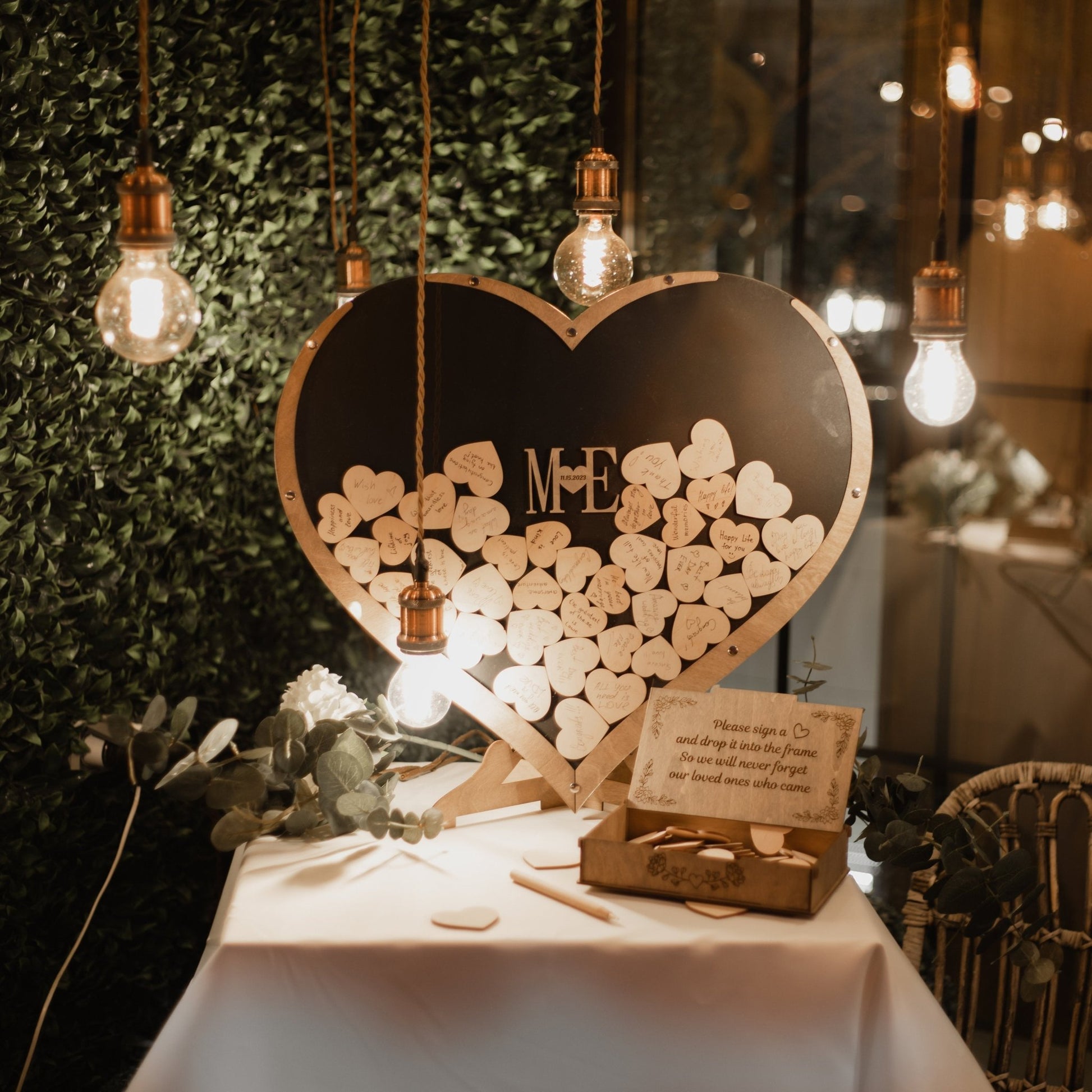 Wooden heart guest book used as wedding decor