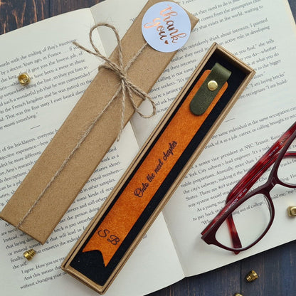 Orange leather bookmark with foil embossed text, designed for an elegant reading experience.