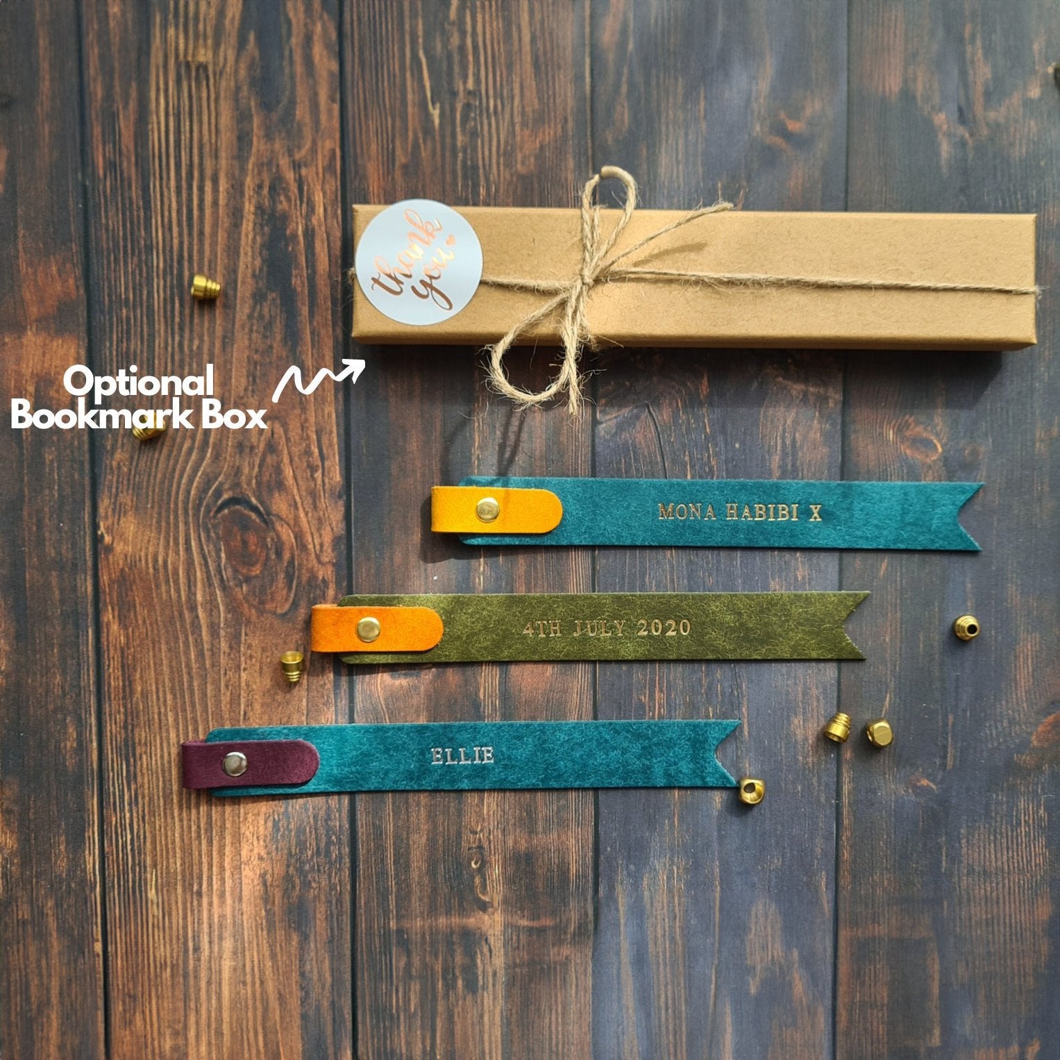 Green leather bookmark with engraved text and a matching box, perfect for gifting.