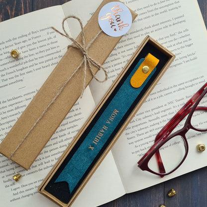 Brown leather bookmark with engraved text and decorative stitching, ideal for book lovers.