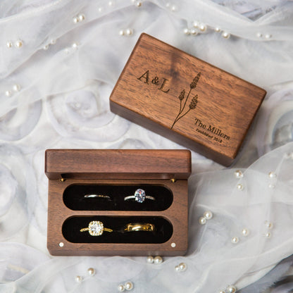 Custom engraved wooden wedding ring box set displaying personalized initials and floral details