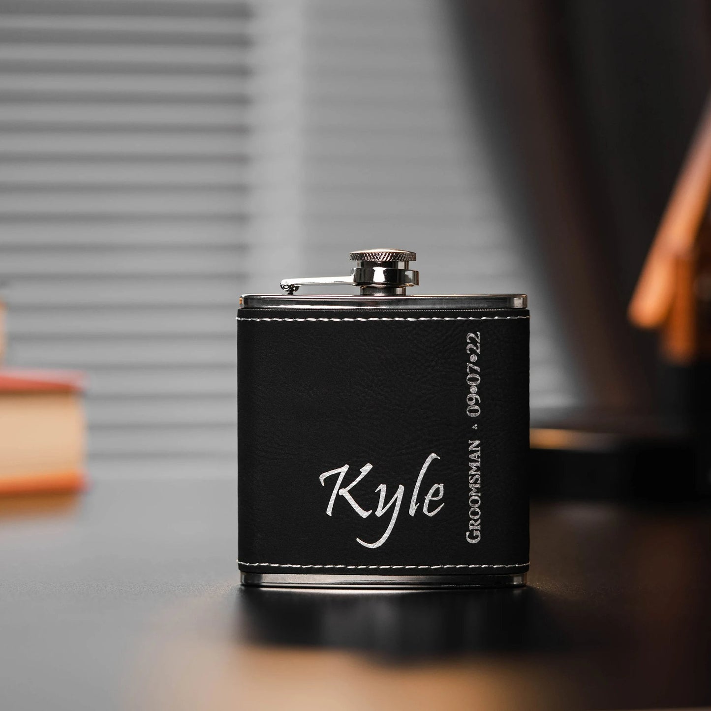 black-leather-flask-with-'kyle'-engraved-alongside-two-shot-glasses-and-a-funnel.