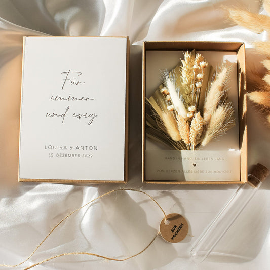 A beautifully arranged wedding keepsake box with a dried flower bouquet and personalized card for Louisa and Anton’s wedding on December 15, 2022.