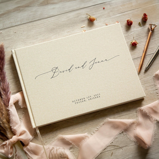 Elegant cream-colored personalized wedding guest book with custom names and wedding date