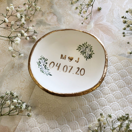 Elegant personalized jewelry dish with gold trim and custom initials.
