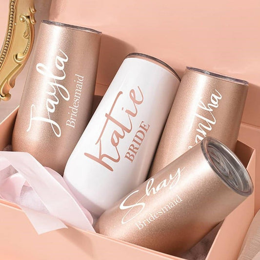Rose gold personalized stainless steel tumbler set with "Bride" and "Bridesmaid" engraving in elegant script font