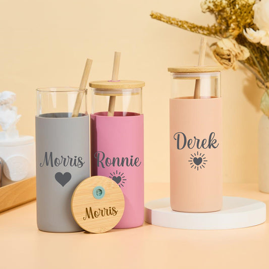 Custom glass tumbler with straw, featuring personalized name.