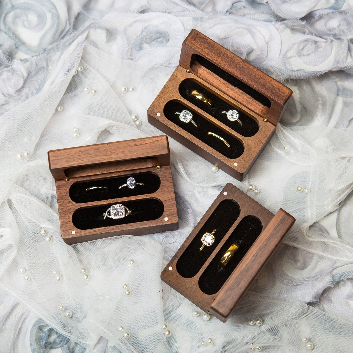 Wooden ring boxes open view showcasing interior ring storage compartments