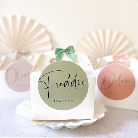 White wedding gift box with green bow and "Freddie" name tag